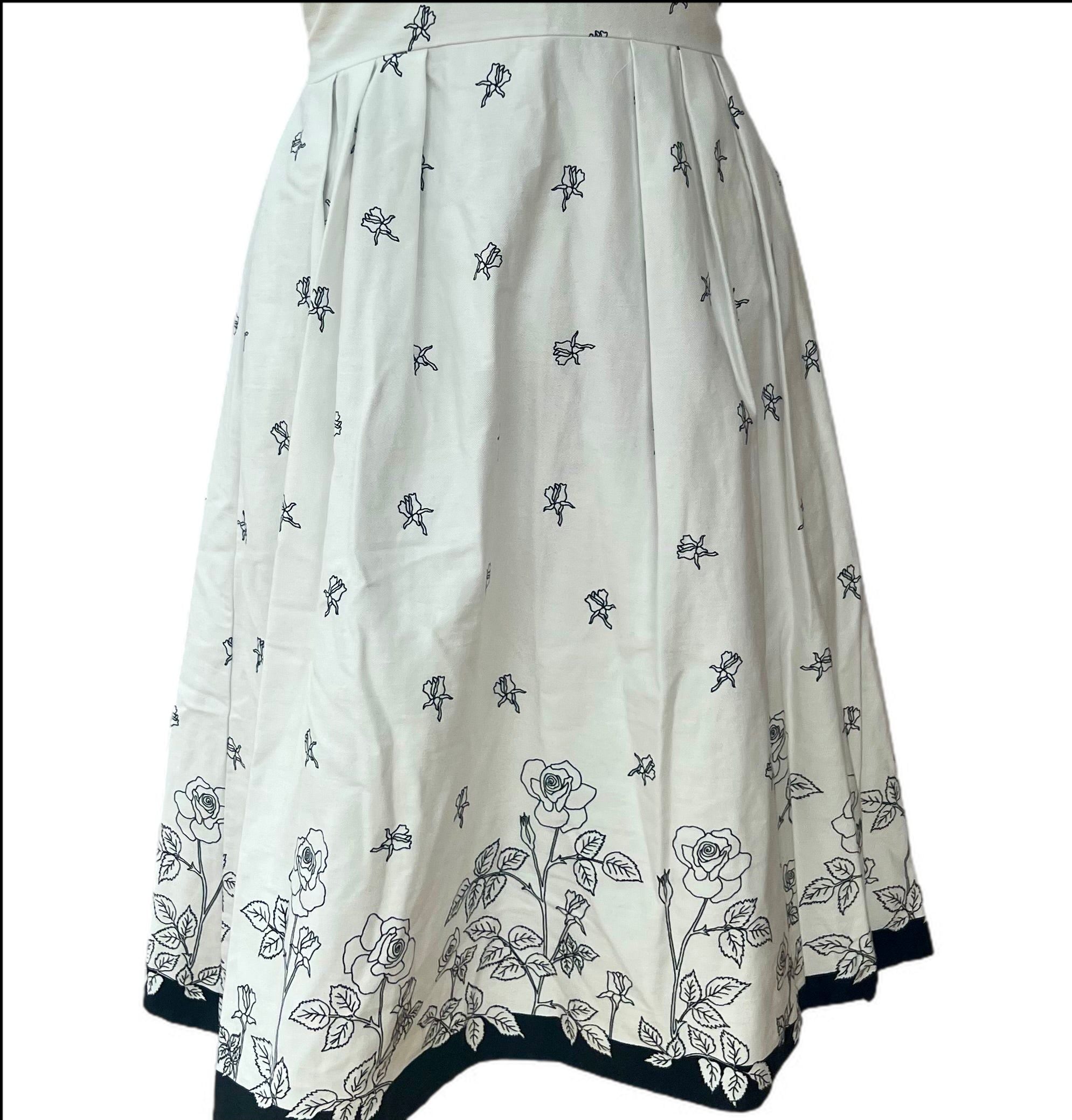 Gorgeous white apron style short sleeve dress with black flowers is made in England